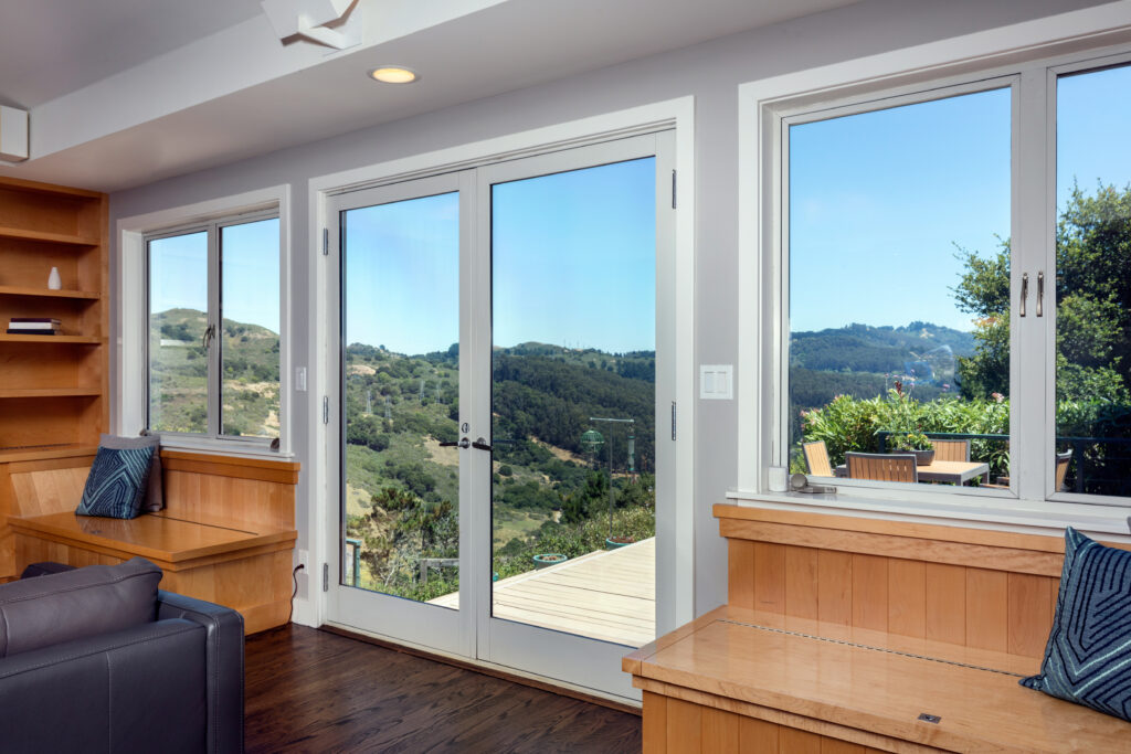 a home with new doors and windows overlooking a beautiful mountain range