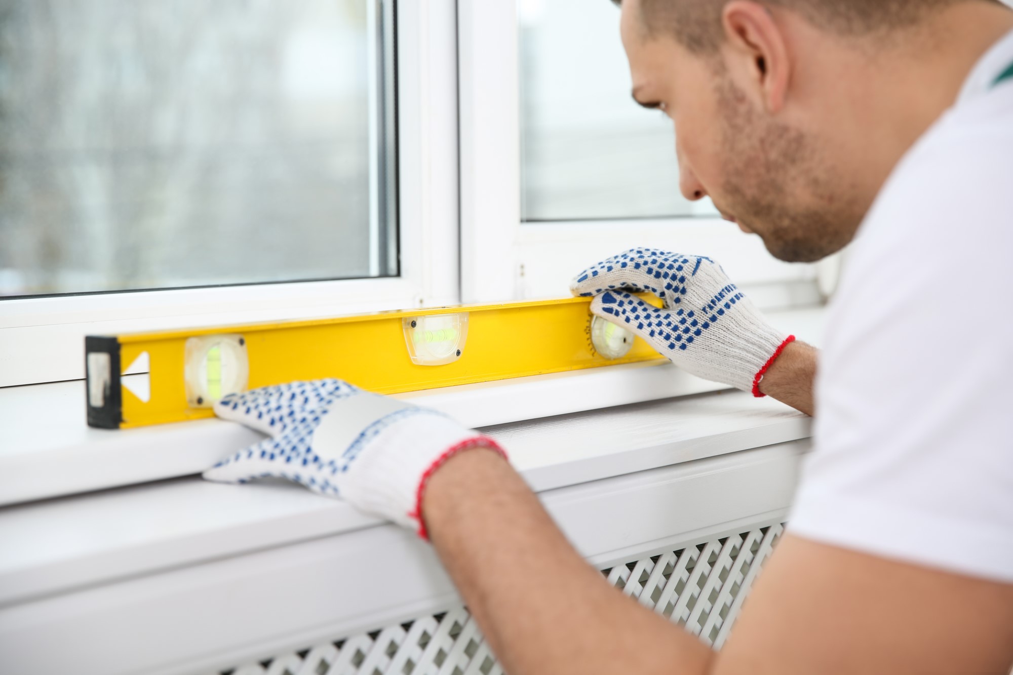 New window installation a worker measuring that balance of the window pane