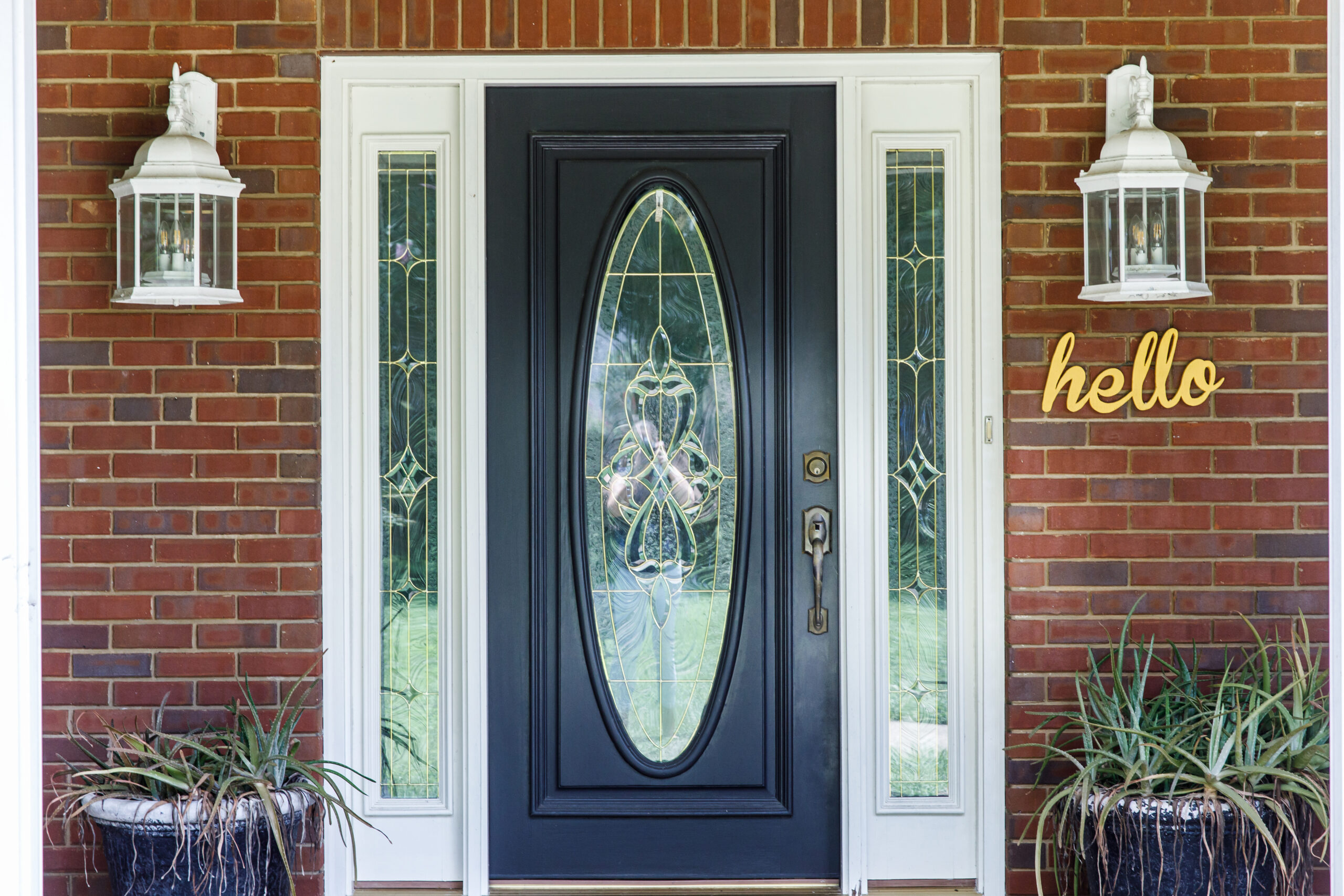 Black Front door of Traditional red brick home